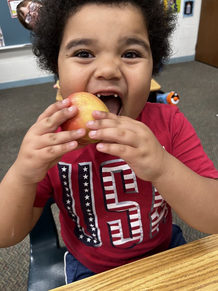 Student Bites Into An Apple For The Great Apple Crunch