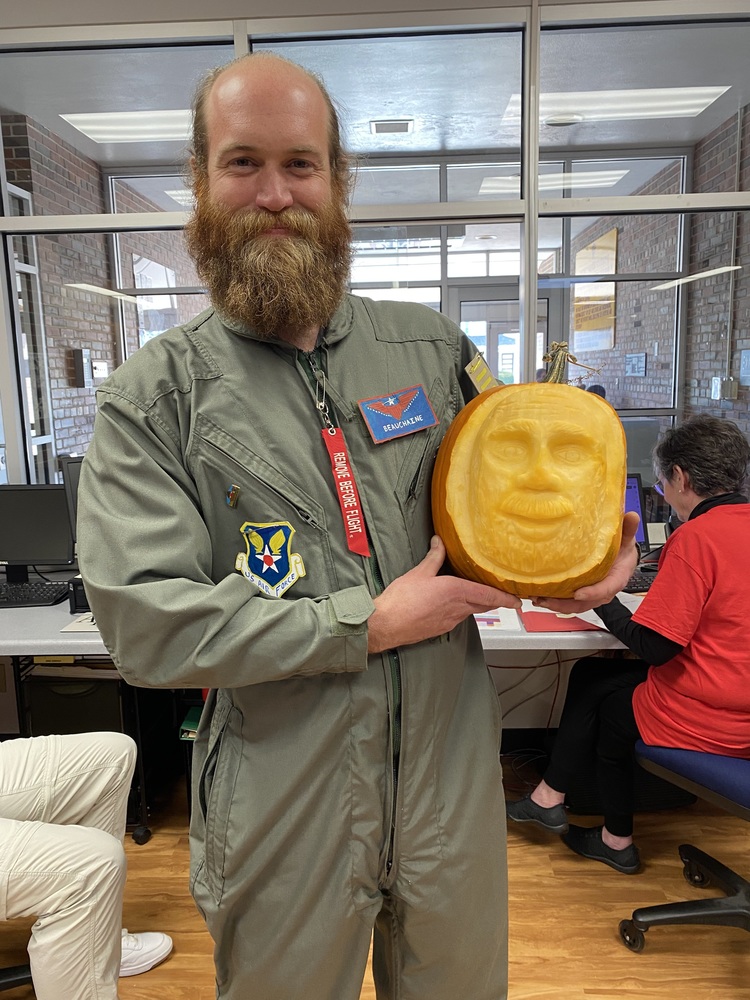 Mr Beauchaine in Costume Holding a Carved Pumpkin Face