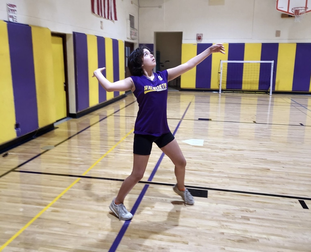 Student Prepares to Serve a Volleyball