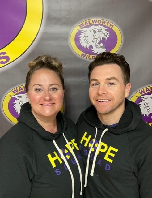 Jennifer Ott-Wilson and Lee Knoble-Janney in Hope Squad Sweatshirts with the Walworth Wildcat Background