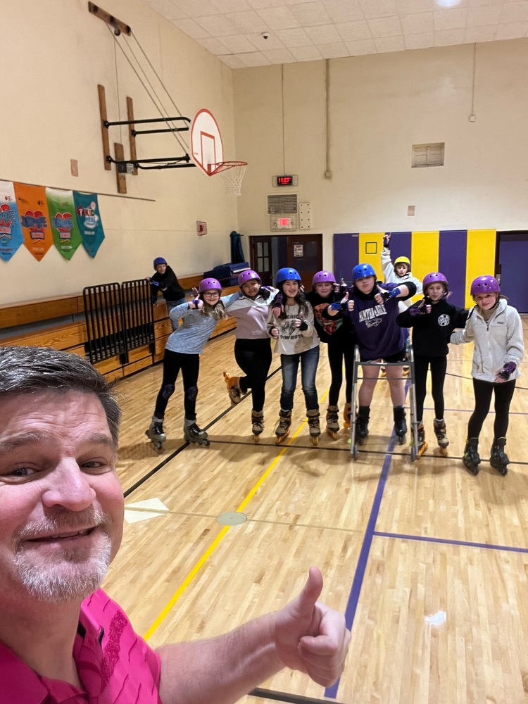 Mr Hummel in the Gym with Students in Roller Skating Equipment